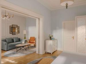 a living room with a couch and a table at Fairmont Le Montreux Palace in Montreux