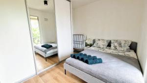 a bedroom with a bed and a large mirror at Luxury in the city 6 Ksiezy Mlyn&FUZJA in Łódź