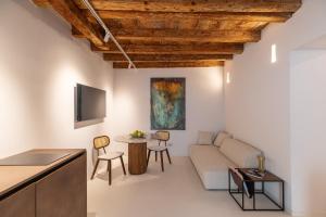 a living room with a couch and a table at Re Carlo - Ortigia Luxury Suite in Syracuse