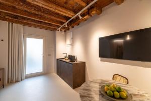 a room with a table with a bowl of fruit on it at Re Carlo - Ortigia Luxury Suite in Syracuse