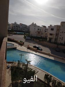 a view of a swimming pool in a parking lot at Dimora Village Challet in Dawwār Muḩammad Abū Shunaynah +12 photos