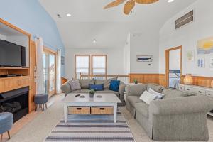 a living room with a couch and a table at Weekend at Pinchys in Kill Devil Hills