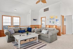 a living room with two couches and a coffee table at Weekend at Pinchys in Kill Devil Hills