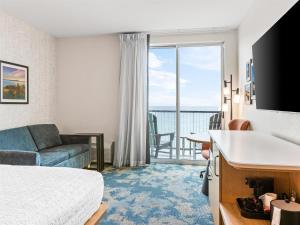 a hotel room with a bed and a view of the ocean at Hampton Inn St Ignace Lakefront Mackinac in Evergreen Shores