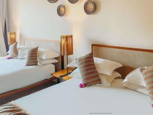 Postel nebo postele na pokoji v ubytování Movenpick Resort Lamantin Saly