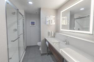 a bathroom with a sink and a toilet and a mirror at Hampton Inn By Hilton Santa Clarita-Valencia in Santa Clarita