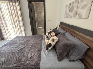 a bedroom with a bed with a dog pillow on it at Family Apartment 2 in Bubaqra