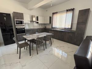 a kitchen with a table and chairs in it at Family Apartment 2 in Bubaqra