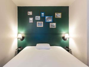 Postel nebo postele na pokoji v ubytování Greet Hotel Limoges Nord
