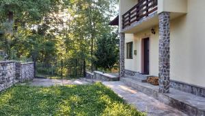 a white house with a gate and a fence at Casa Damian in Bertea