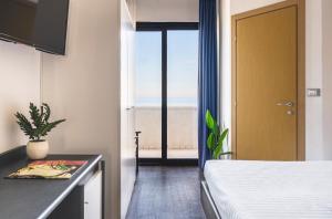 Postel nebo postele na pokoji v ubytování Hotel Acropolis