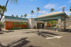 an airport showroom with palm trees in a parking lot at Airport Honolulu Hotel, Trademark Collection by Wyndham in Honolulu