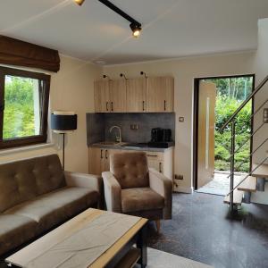 a living room with a couch and a table at Osada Prado in Michałkowa