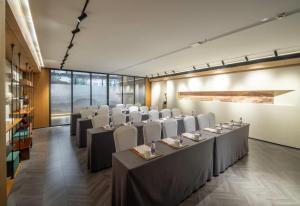 a row of tables and chairs in a room at Ramada by Wyndham Hangzhou Yuhang in Hangzhou