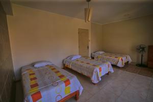 Postel nebo postele na pokoji v ubytování Hotel Rumi Wasi
