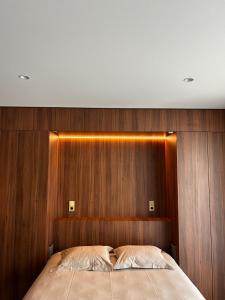 a bedroom with a wooden headboard and a bed at Core Luxembourg -Studio Parking -50 Cents in Luxembourg