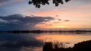 a sunset over a large body of water at Agroturystyka - TI AMO Nielisz in Nielisz +28 photos