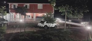 a white car parked in front of a house at night at Casa Greta La Dimora delle Fate in Villaggio Laceno