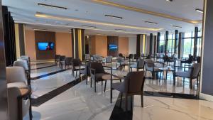 a restaurant with tables and chairs in a room at PALEMON Resort& Spa in Manavgat