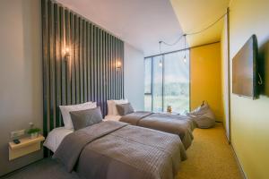 Cama ou camas em um quarto em Urbihop Hotel