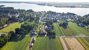 an aerial view of a village with a lake at Agroturystyka - TI AMO Nielisz in Nielisz