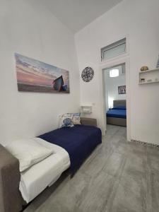 a bedroom with a bed and a painting on the wall at Giomasue' in Porticello