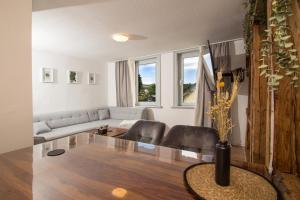 a living room with a couch and a table at THEFIVE60 Apartments in Braunlage