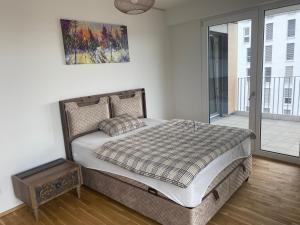a bedroom with a bed and a large window at InterAssist 15 in Heidelberg