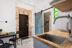 a kitchen with a sink and a table with chairs at Carlson near Enerdgylandia in Zator