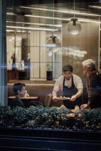 two men standing in a restaurant preparing food at Grand Brizo Bel Air in Buenos Aires +82 photos