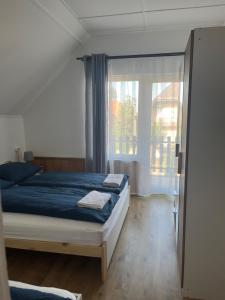 Postel nebo postele na pokoji v ubytování Roland Ház