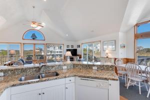 a kitchen with a sink and a counter top at Sea-renity in Corolla