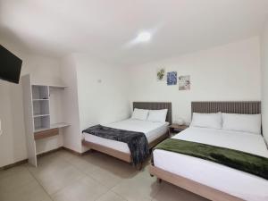 Voodi või voodid majutusasutuse Hotel Fuente Real Popayán toas