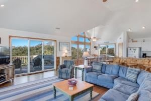 a living room with a couch and a table at Sea-renity in Corolla