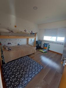 ein Schlafzimmer mit einem Etagenbett und einem Teppich in der Unterkunft Casa Grande para 7 personas in Balneario Claromecó