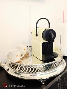 a toaster and two cups on a tray on a counter at Royal Lux in Sagunto +58 photos