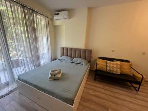 a bed with a pair of shoes sitting on it at Bamboo beach tsikhisdziri in Kobuleti +6 photos