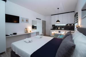 a bedroom with a large bed and a living room at Studioapartment Black & White in Velika Gorica