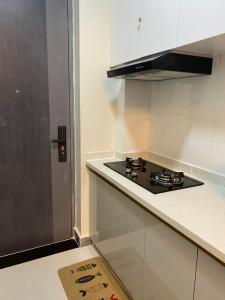 a kitchen with a stove and a counter top at Kaya Homes , Studio 23 mins to JKIA in Nairobi
