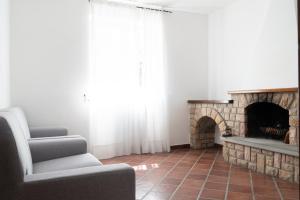 a living room with a couch and a fireplace at Villa Alloro in Massa Lubrense