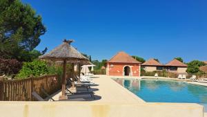 a swimming pool with chairs and a gazebo at Studio Prayssac in Prayssac