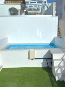 a swimming pool on the roof of a house at Villa Serenity Tapada - Pool, Cinema Room & Gym in Nazaré