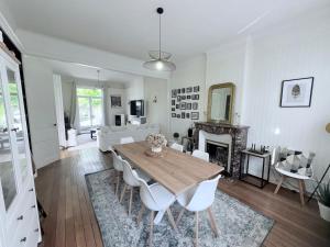 a living room with a wooden table and chairs at Magnificent Bourgeois Residence on Wooded Estate in Charleville-Mézières