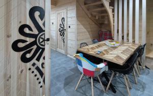 una sala da pranzo con tavolo e sedie in legno di Wygodno a Szlembark