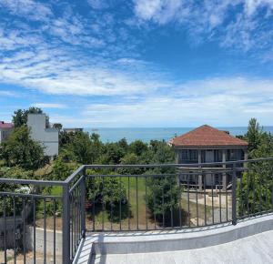 a balcony of a house with a view of the ocean at Mirza Guesthouse in Batumi