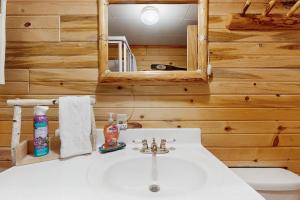 a bathroom with a white sink and a mirror at The Creekside Cabin in Cascade +21 photos