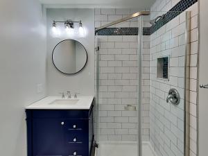 a bathroom with a sink and a shower with a mirror at Saltcreek Sunsets in Tybee Island +88 photos