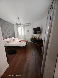 a bedroom with a bed and a television in it at Royal Lux in Sagunto