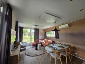 a living room with a table and a couch at Waddenlodge Deluxe in Harlingen
