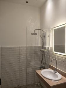 a bathroom with a sink and a glass shower at Talaat Harb Hotel in Cairo